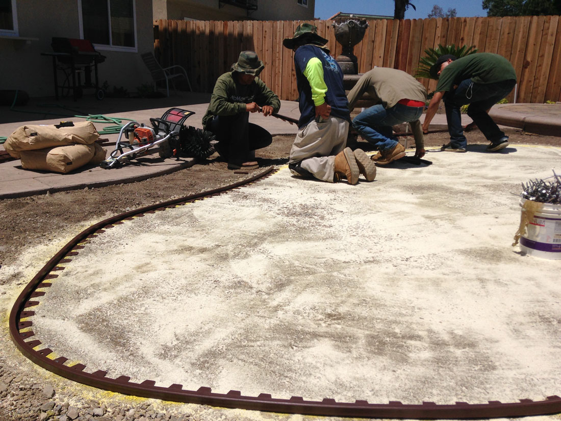 artificial turf border installation in process