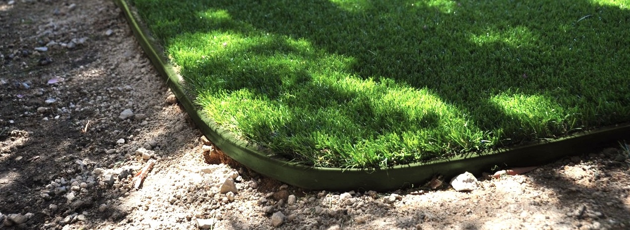 synthetic turf supplies green in shady areas where grass doesn't grow