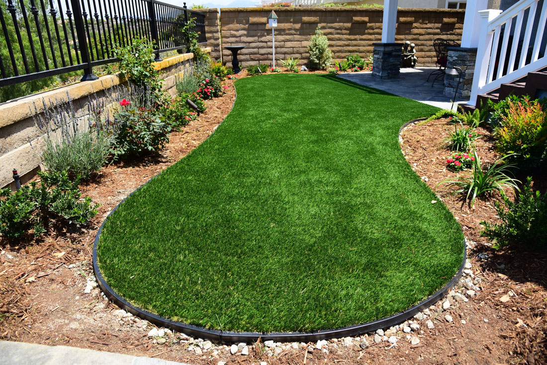 artificial turf border holds base in place at edge of white staircase