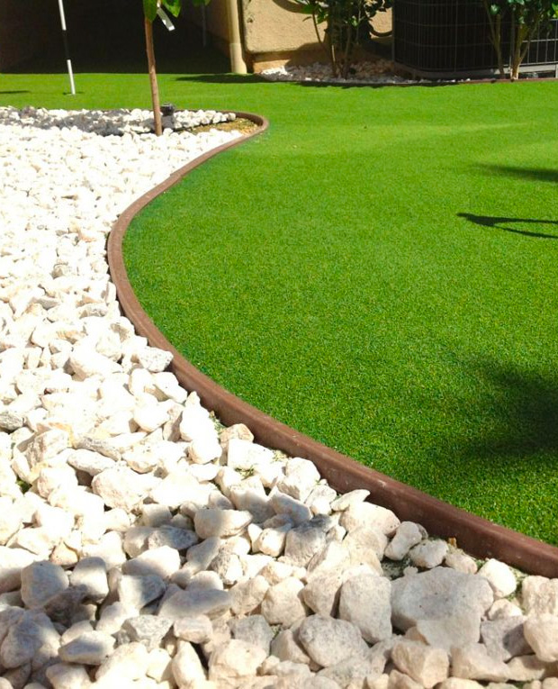 brown lawn edging for artificial grass, white marble landscape rocks, green artificial grass in curved design